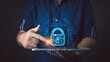 © death_rip - A person interacts with a glowing lock icon on a tablet, symbolizing secure cyber data protection, showcasing technology, innovation, and safeguarding sensitive information in the digital age.