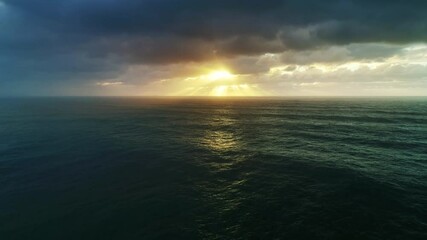 Wall Mural - aerial view on big waves of atlantic ocean and dramatic sunset sky, 4k