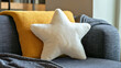 © uros - A cozy living room featuring a star-shaped white pillow on a stylish sofa, with soft textiles and vibrant accents, adding a playful and comfortable touch to the modern, family-friendly space.