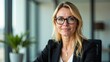 © svetatata - Portrait of serious desirable adult woman in glasses caucasian appearance with blonde hair sitting in office