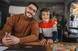 © Miljan Živković - Portrait of young boy and male speech therapist during class at home