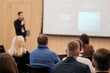 © Anton Gvozdikov - Attendees focusing on a presenter speaking at a business conference or seminar session.