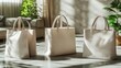 © Dikina - Three beige tote bags displayed in a sunlit indoor setting.