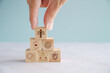 © SewcreamStudio - Hand holding wooden block with Ethical icons, business ethics and corporate compliance concept