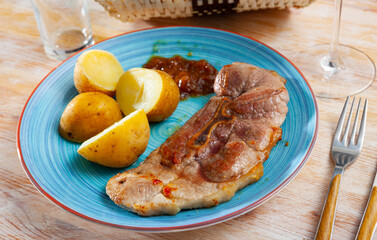 Wall Mural - Close up of delicious baked pork with potatoes, served on plate