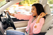 © Prostock-studio - Road Trip Concept. Profile side view portrait of excited playful black woman driving luxury car, dancing to music and singing favorite song, resting on weekend going on vacation or home from work