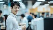 © twilight mist - Young Man Smiles Holding Coffee In Modern Office Setting