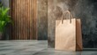 © Pairat - A simple paper bag stands against a textured wall in a modern setting.