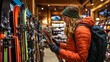 © Masque - Woman selects ski gear for mountain adventures at a shop.