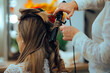 © nicoletaionescu - Hairdresser Using Hair Curler for Special Day Hairstyle. Hairstylist using curling iron to make a new hairdo for a client