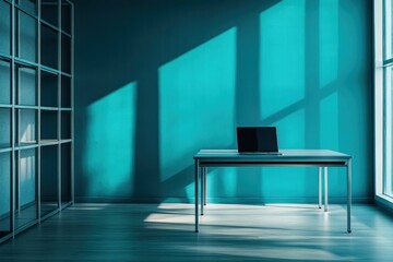 Poster - A minimalist office space with a laptop on a table, featuring dramatic lighting and shadows.