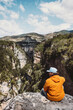 © EVERST - Man traveler sitting on cliff with Osumi canyon view  travel in Albania outdoor healthy lifestyle hiker in mountains alone with nature active summer vacations tour