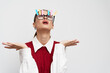 © SHOTPRIME STUDIO - Creative expression of surprise or excitement by a young woman wearing glasses with colorful notes on her forehead, set against a plain white background