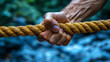 © YoursTrulyPhotos - hand gripping tightly onto a rope symbolizing resilience strength determination and the power to overcome challenges through focus perseverance and inner will