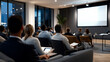 © Kevin - Diverse group of professionals seated in a modern seminar room with a presenter at the front