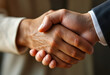 © Valentin - Two hands shaking in a warm handshake, conveying trust, agreement, or partnership