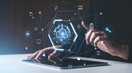 hands interacting with digital cloud storage icons on a tablet in a futuristic holographic interface