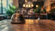 © Elshad Karimov - A vintage service bell rests on a rustic wooden table amidst a blurred backdrop, inviting patrons to summon assistance with its distinctive chime.