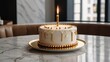 © Sabar AI - Photo of a birthday cake with a combination of gold and white colors with one candle with a luxurious impression