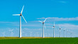 © Fokke Baarssen - Windmill turbines generating electric green energy with a blue sky green energy concept, windmill park in the Noordoostpolder the biggest wind farm in the Netherlands