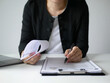 © Ople - Young businesswoman holds a resume and evaluates it. Views the personal history of job applicants. Recruitment concept