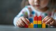 © K silver - Child engaged in creative play with colorful building blocks home photography indoor close-up imagination