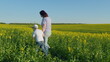 © artifex.orlova - Joyful Happy Family Walking Through Blooming Rapeseed Field Of Yellow Flowers. Happy Freedom Outdoors Concept. Rural Scene.