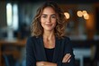 © btiger - Confident Latin businesswoman executive standing in modern office smiling in suit with arms crossed looking successful at work