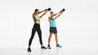 © master1305 - Full-length image of young sportive man and woman with sportive bodies, training, doing exercises with kettlebell against white background. Concept of sport, active and healthy lifestyle, workout, ad