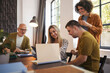 © Westend61 - Person with disability working with colleagues in inclusive community office