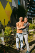 © Westend61 - Happy couple hugging in an urban community garden.