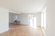 © Westend61 - Nearly empty room with wooden floor and natural light in a home under construction