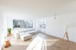 © Westend61 - Bright and spacious minimalist living room with large windows in a home under construction