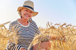 © Westend61 - Smiling mature woman amidst wheat crops in farm