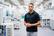 © Westend61 - Portrait of a confident employee in a factory
