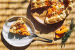 © Westend61 - Delicious seasonal tart with baked pumpkin, brie cheese and herbs on wooden table