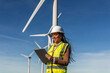 © EDER - Latin american female engineer using tablet in wind turbine power plant generating green energy