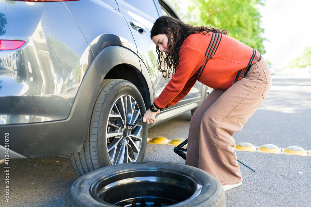 Teenage girl displaying self-sufficiency and automotive maintenance ...