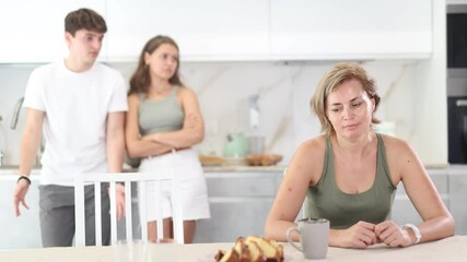 Wall Mural - Portrait of thoughtful woman who had conflict with adult children while cooking dinner in kitchen