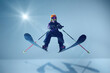 © Lustre Art Group  - Ski jumper in vibrant orange helmet, soaring mid-air against light blue gradient background, sunburst adding dynamic light to scene, focus on movement and gear. Concept of extreme sport, holidays. Ad