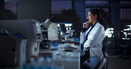 Aufkleber - Hispanic Female Scientist Working on a Computer in the Evening. Specialist Using a Gene Sequencing Online Software. Advanced Biotechnology Lab in a Medical Research and Development Center