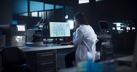 Leinwandbilder - Medical Research and Development Laboratory: Dedicated Caucasian Female Scientist Working on a Computer with Advanced DNA Diagnostic Software. Modern Genetic Engineering Lab at Night