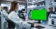 © Gorodenkoff - Asian Female Scientist Working on a Desktop Computer with a Green Screen Chroma Key Mock Up Display. Advanced Biotechnology Lab in a Medical Research and Development Center