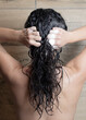 © Victoria Kluy - Dark curly hair washing with shampoo