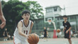 © pattozher - Basketball Player Focus: A young basketball player dribbles the ball with determination, his gaze fixed on the court, showcasing the intensity and focus of a true athlete.