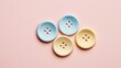 © TheStoodio - Buttons with textured finish on a pastel background, great for crafting ideas.