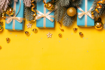 Wall Mural - christmas background with pine tree, gifts and festive decorations top view. christmas flat lay. cop
