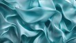 © Dulemegapixel - The image showcases flowing, teal-colored fabric displaying a smooth and elegant form reminiscent of gentle ocean waves, portraying calmness and fluidity.