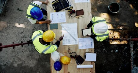 Poster - Above, men and paper on construction site for planning, urban development and project management with tablet. Engineer team, blueprint and talking at equipment for building renovation in architecture