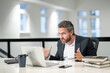 © Volodymyr - Modern office. Angry caucasian business man in business suit using laptop, working remotely, e-commerce online at office. Finance auditor. Ceo manager employee having business idea. Business startup.